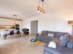 a living room with a couch and a table at Apartment Le Cyrnos by Interhome in Saint-Aygulf +31 photos
