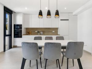 a kitchen with a dining room table and chairs at Apartment Tropical Beach Penthouse by Interhome in Santiago de la Ribera