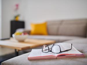 a book with glasses on top of it on a couch at Holiday Home Villa Maris by Interhome in Brtonigla