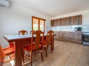 a kitchen with a wooden table and wooden cabinets at Holiday Home Nola by Interhome in Viskovo