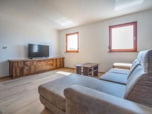 a living room with a couch and a flat screen tv at Holiday Home Nola by Interhome in Viskovo