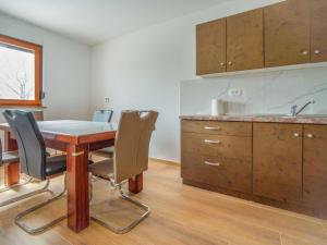 a kitchen with a wooden table and chairs and a sink at Holiday Home Nola by Interhome in Viskovo