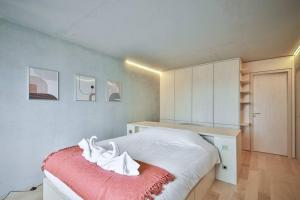 a bedroom with a white bed with a red blanket at Luxurious flat/3bedrooms/Amazing view/EffeilTower in Paris