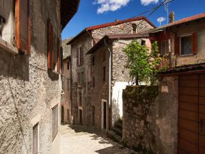 an alley in an old town with buildings at Apartment Ca' Dolce Osteno by Interhome in Claino