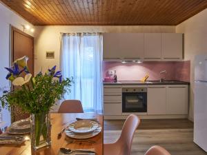 a kitchen and dining room with a wooden table at Apartment Ca' Dolce Osteno by Interhome in Claino