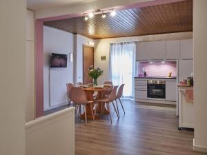 a kitchen and dining room with a table and chairs at Apartment Ca' Dolce Osteno by Interhome in Claino