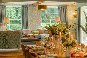 a living room with a table and a couch at The Farmhouse, Nether Hall Estate in Pakenham