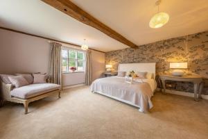 A bed or beds in a room at The Farmhouse, Nether Hall Estate