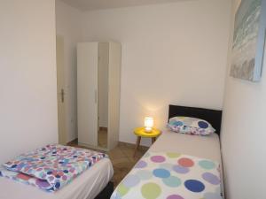 a small room with two beds and a small table at Apartment Tino-3 by Interhome in Sukošan