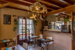 a dining room with two tables and a chandelier at Agua Viva Eco H Wellness Castro Urdiales in Castro-Urdiales