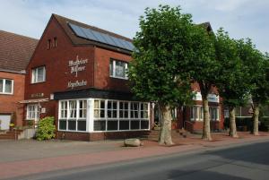 a red brick building with a solarium on it at Hotel Restaurant Lütkebohmert in Reken