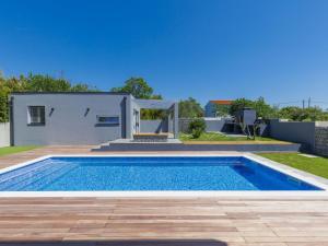 a swimming pool in the backyard of a house at Holiday Home Villa Dora by Interhome in Pula