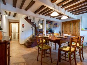 a kitchen and dining room with a wooden table and chairs at Holiday Home Kenzo by Interhome in Casabasciana