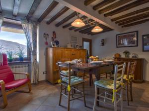 a dining room with a wooden table and chairs at Holiday Home Kenzo by Interhome in Casabasciana