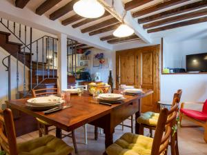 a dining room with a wooden table and chairs at Holiday Home Kenzo by Interhome in Casabasciana