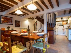 a kitchen and dining room with a wooden table and chairs at Holiday Home Kenzo by Interhome in Casabasciana +28 photos