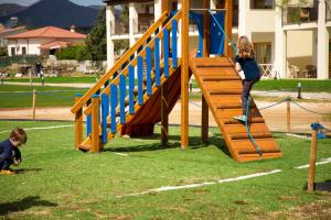 Ein junges Mädchen spielt auf einem Spielplatz mit einem Seil in der Unterkunft Stella Marina Budoni in Budoni