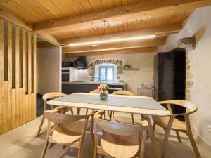a kitchen and dining room with a table and chairs at Holiday Home Jerini Main House by Interhome in Vrh