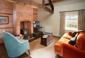 a living room with a couch and a fireplace at The Groom's Flat in Leominster