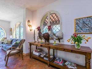 a living room with a table with two roosters on it at Villa Loris-2 by Interhome in Riparbella