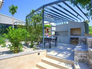 a patio with a table and chairs in a yard at Holiday Home Jerini The Barn by Interhome in Vrh