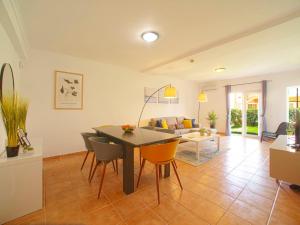 a dining room and living room with a table and chairs at Holiday Home Sunset Terrace by Interhome in Pêra