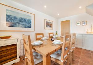 a dining room with a wooden table and chairs at Seafarers in Seahouses +8 photos