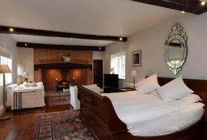 a bedroom with a large bed and a fireplace at Ayres End Studio in Kersey