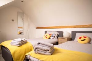 a bedroom with two beds with towels on them at Rose Cottage in Shrewsbury