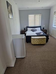 a bedroom with a bed and a trash can at Spacious Luxurious Serviced Accomodation in Doncaster
