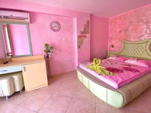 a pink bedroom with a large bed in a room at Boutique Guest House 'Sofia' in Nesebar +211 photos