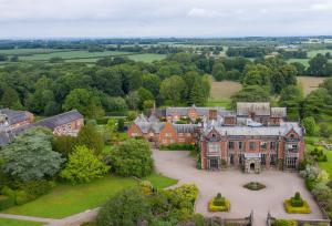 an aerial view of a large house with a courtyard at Laundry Cottage in Pickmere
