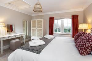 a bedroom with a large white bed and a window at East House in Pickmere