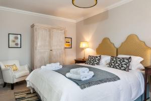 a bedroom with a bed with two towels on it at West Gables in Pickmere