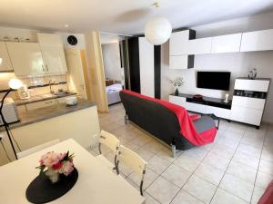 a kitchen and living room with a couch and a table at Appartement Six-Fours-les-Plages, 2 pièces, 4 personnes - FR-1-316-16 in Six-Fours-les-Plages