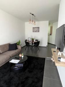 a living room with a couch and a table at FDS Cosy Apartment in Ghent