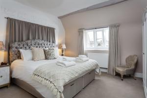 a bedroom with a large bed with towels on it at The Gables in Cow Honeybourne
