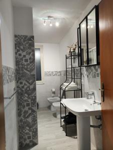 a bathroom with a sink and a toilet at Casa Josè Suite Mare in Palermo