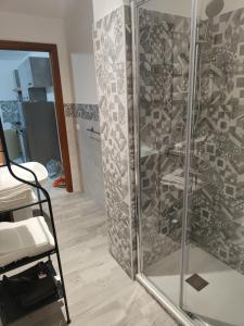 a shower with a glass door in a room at Casa Josè Suite Mare in Palermo