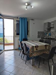 a kitchen and dining room with a table and chairs at Casa Josè Suite Mare in Palermo