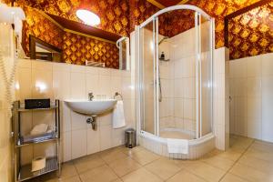 a bathroom with a shower and a sink at Hotel Grand Vígľaš in Zvolen