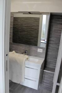 a bathroom with a sink and a mirror at appartement Menton au coeur de la vieille ville in Menton