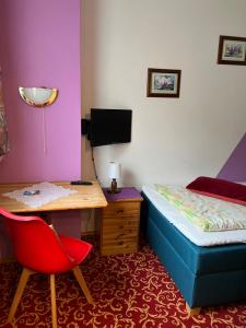 a bedroom with a bed and a desk and a deskablish at ​Gästehaus Frans-Jozef in Mönichkirchen