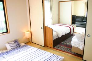 Postel nebo postele na pokoji v ubytování 山中湖リゾートハウスⅡ