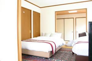 Кровать или кровати в номере 山中湖リゾートハウスⅡ