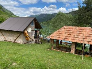 a house and a building with a roof at Kamp jezero Stari Brod 