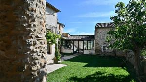 an exterior view of a house with a yard at Mas de Chassole Les Gîtes de l'Aurore in Ongles