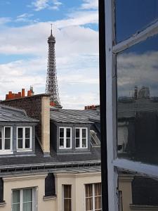 a view of the eiffel tower from a window at Studio Passy - Tour Eiffel in Paris