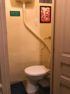 a bathroom with a toilet and stairs in it at Studio Passy - Tour Eiffel in Paris