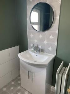 a bathroom with a sink and a mirror at The Court in Belfast +16 photos